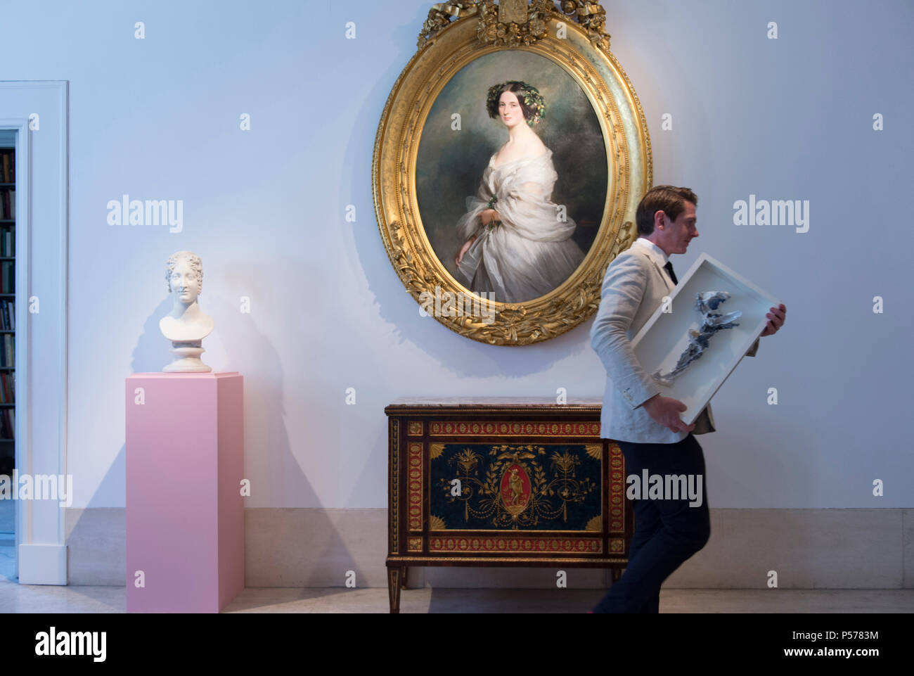 Robilant +Voena, Dover Street, London, UK. 25 Juin, 2018. Dans le cadre de la Semaine de l'Art de Londres Mayfair gallery présente des portraits de la société y compris l'ovale Portrait de femme ; Thérèse Freifrau Von Bethmann, 1850 par Franz Xaver Winterhalter avec gallery manager Benoît Tomlinson passant tenant un travail de la céramique contemporaine par Lucio Fontana, Crocifisso (crucifix), 1955. L'Art de Londres ouvre la semaine du 28 juin au 6 juillet avec un large éventail d'expositions d'art dans les grandes concessions automobiles à St James et Mayfair à Londres. Credit : Malcolm Park/Alamy Live News Banque D'Images