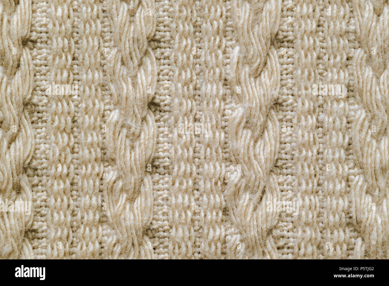 Pull en texture. Pigtails sur tissu tricot la texture. Chandail tricoté Machine Background Banque D'Images