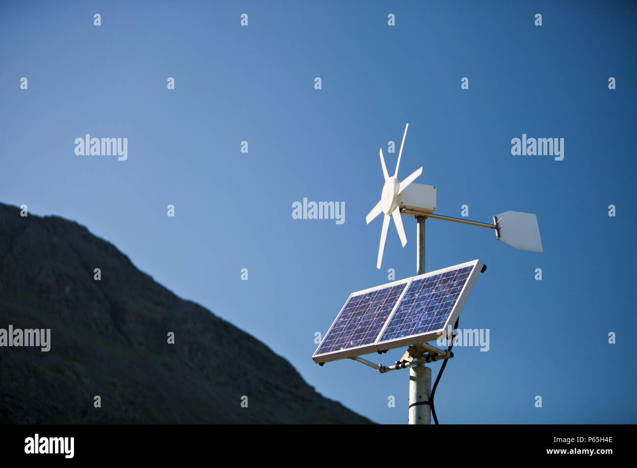 Un panneau électrique solaire et éolienne utilisée pour alimenter un panneau routier au néon sur la puce, Lakle District, UK. Banque D'Images