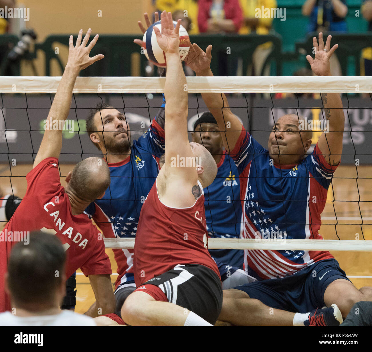 Vétéran de l'armée américaine Robbie Gaup, gauche, U.S. Special Operations Command Sgt. 1re classe Alfred Martinez, droite, et ancien combattant de l'armée américaine Alexander Shaw, centre, jouer contre le Canada lors de la compétition de volleyball assis lors d'Invictus 2016 au Jeux ESPN Wide World of Sports à Walt Disney World, Orlando, Floride, le 7 mai 2016. Sont également sur la photo U.S. Special Operations Command SFC. Alfred Martinez, à gauche de l'armée américaine et vétéran Robbie Gaup, droite. L'Invictus Jeux sont la version du Royaume-Uni du guerrier Jeux, réunissant les anciens combattants blessés de 14 pays pour des événements y compris la voie Banque D'Images