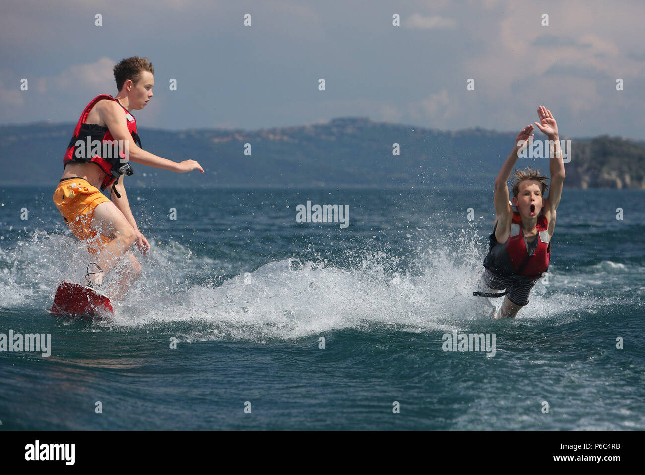 Capodimonte, Italie, les garçons tombent dans l'eau tandis que le ski sur le lac de Bolsena Banque D'Images
