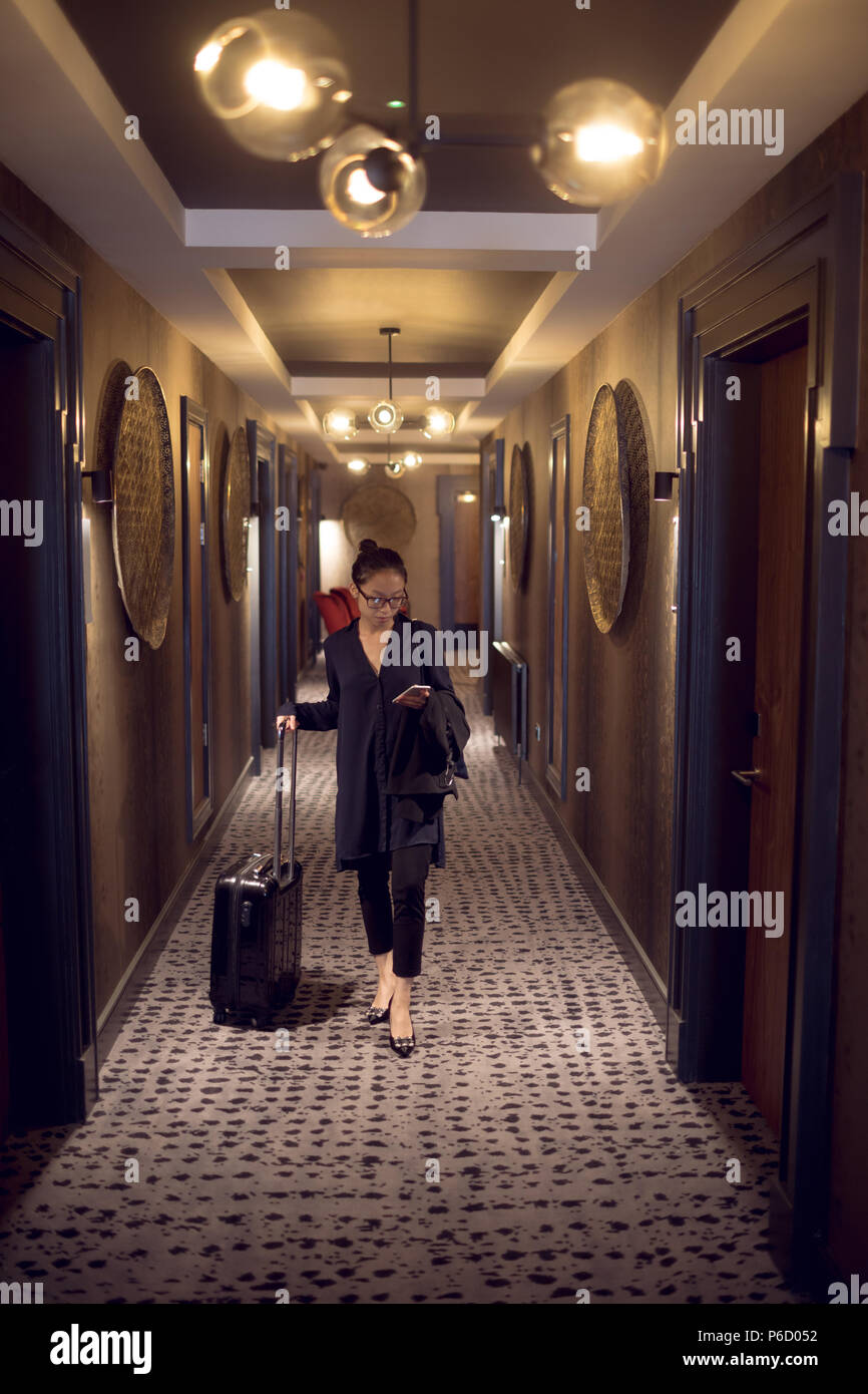 Femme avec sac chariot marcher dans le couloir Banque D'Images
