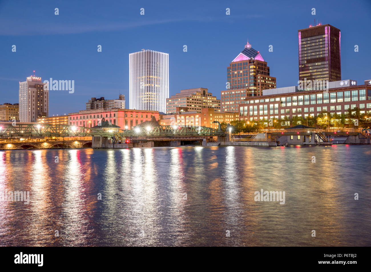 Rochester, New York : un horizon de la ville au crépuscule le long de la rivière Genesee. Banque D'Images