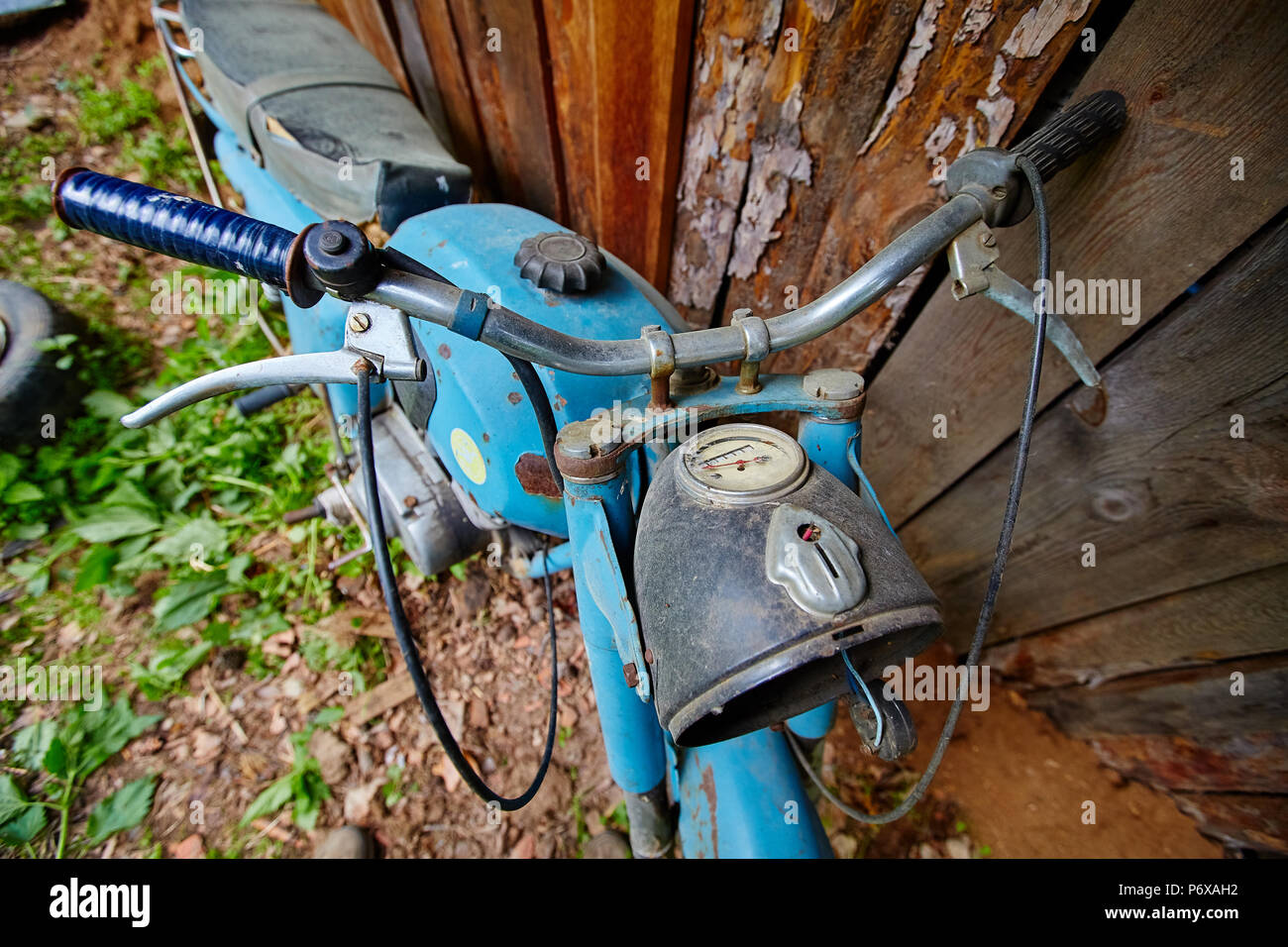 Un vieux stand moto abandonnée près d'une clôture dans le village Banque D'Images