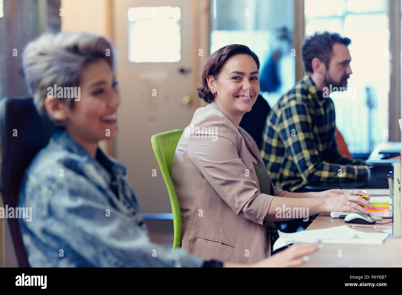 Portrait confiant, creative in open plan office Banque D'Images