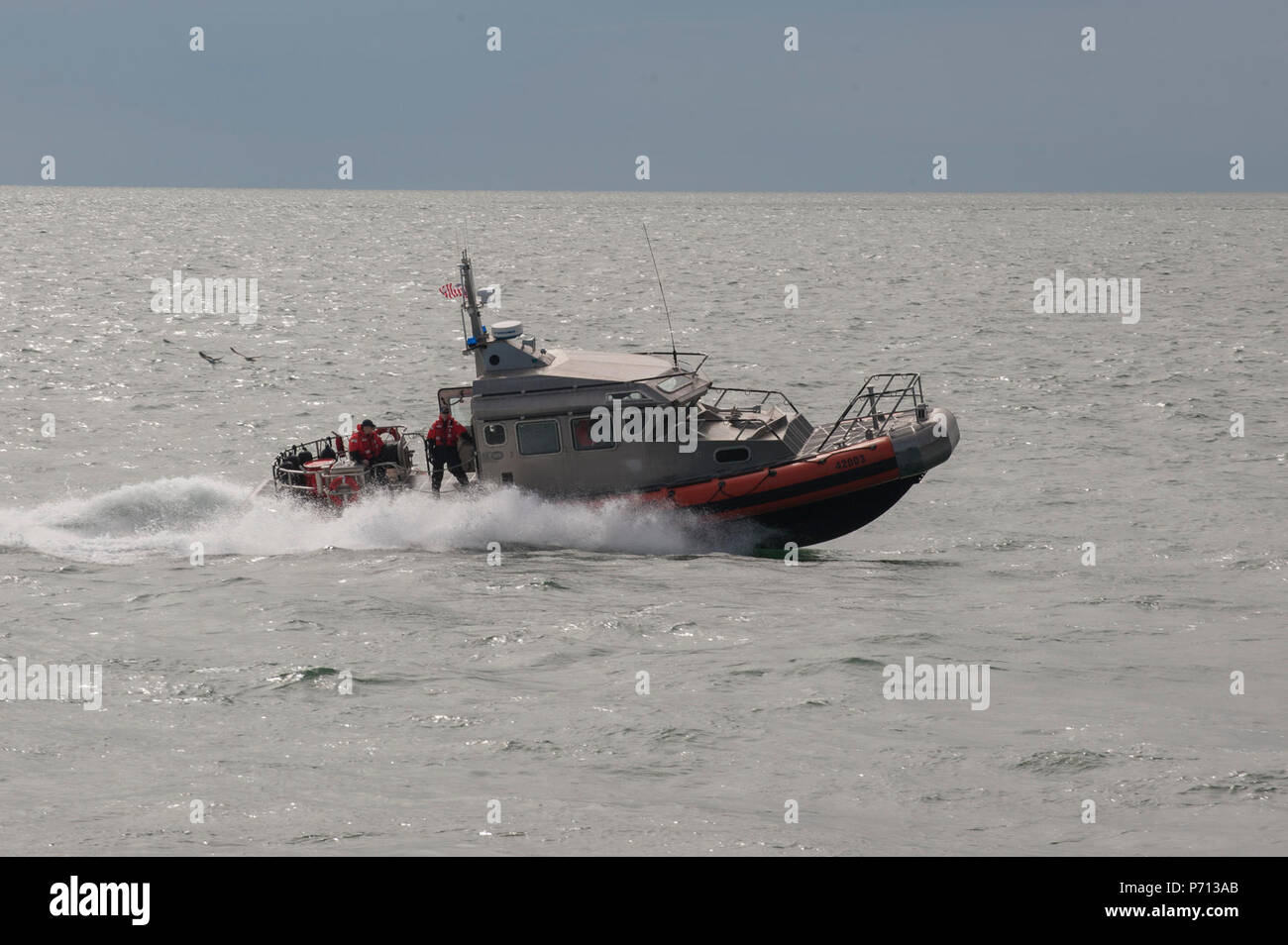 Un petit bateau de l'équipage de la station de la Garde côtière canadienne Chatham répond à un rapport d'un bateau de pêche en feu, jeudi 11 mai, 2017, au nord de Cape Cod, Massachusetts. Garde-côte de chêne, un baliseur, était dans la région à l'époque et a également lancé un petit bateau pour l'aider. (Garde côtière canadienne Banque D'Images