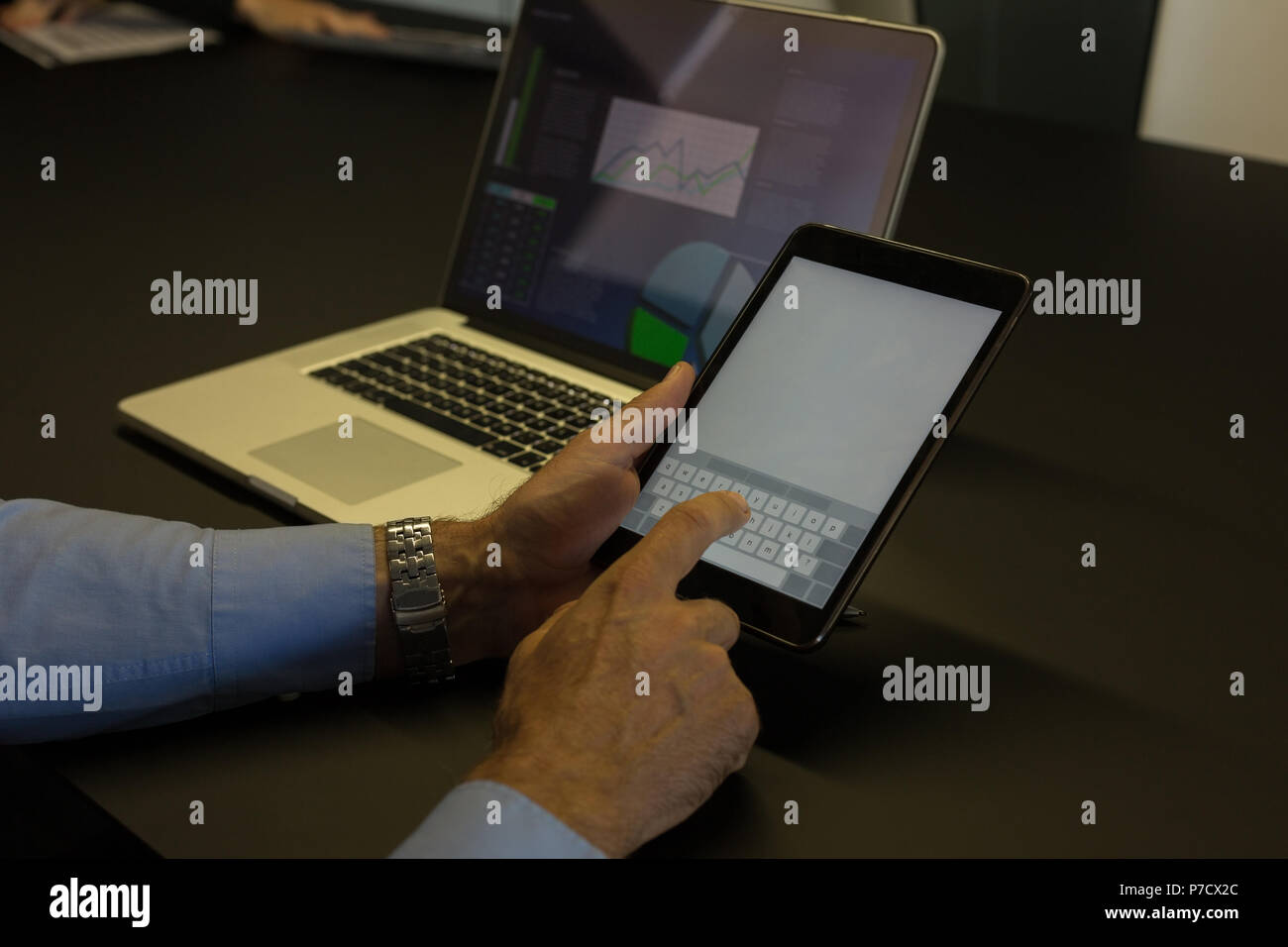 Businessman using digital tablet in conference room Banque D'Images