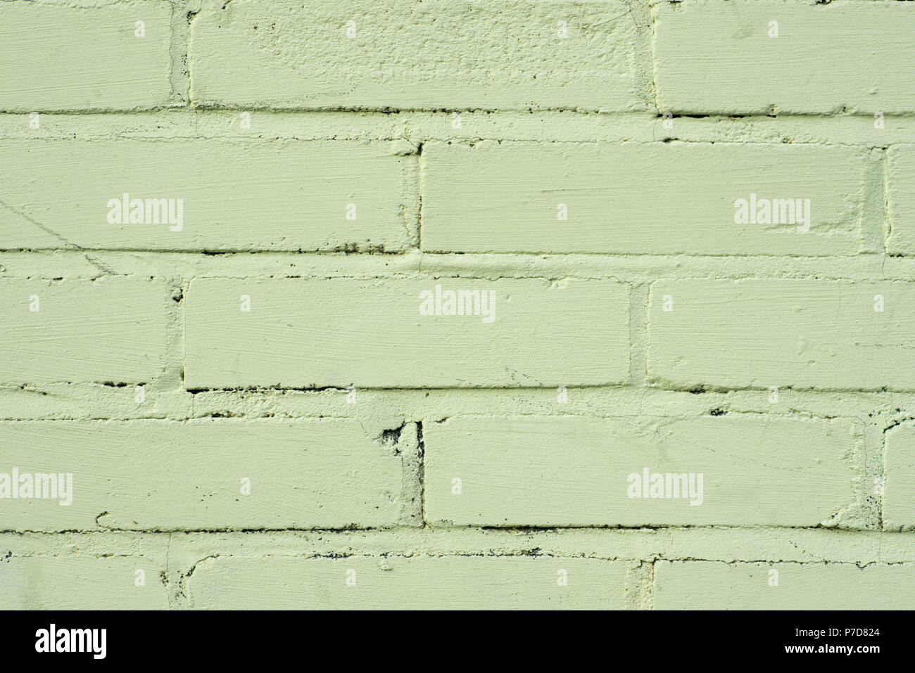 Vieux mur de briques peint couleur pistache texture background Banque D'Images