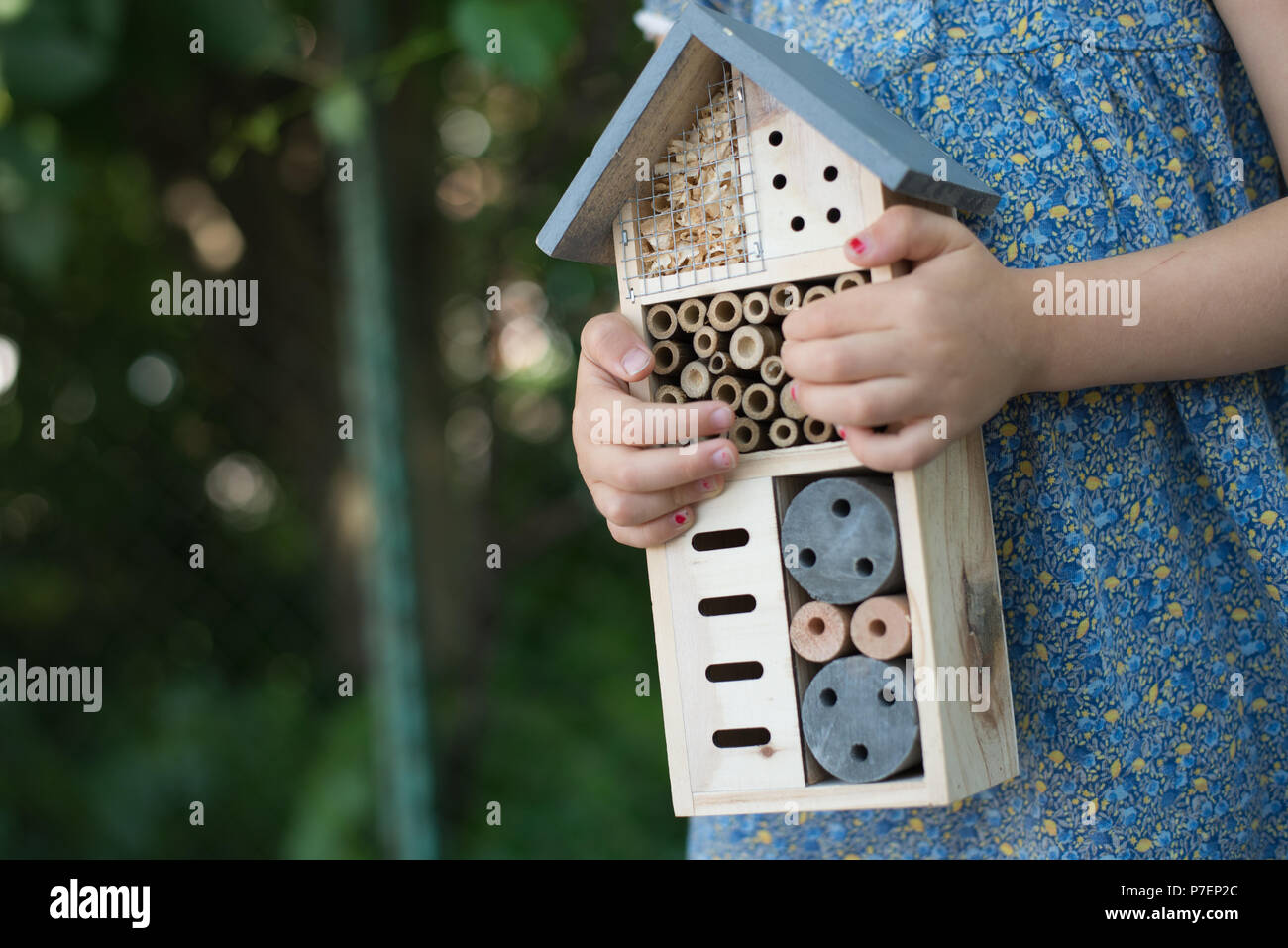 L'école verte. Girl holding hôtel insectes Banque D'Images