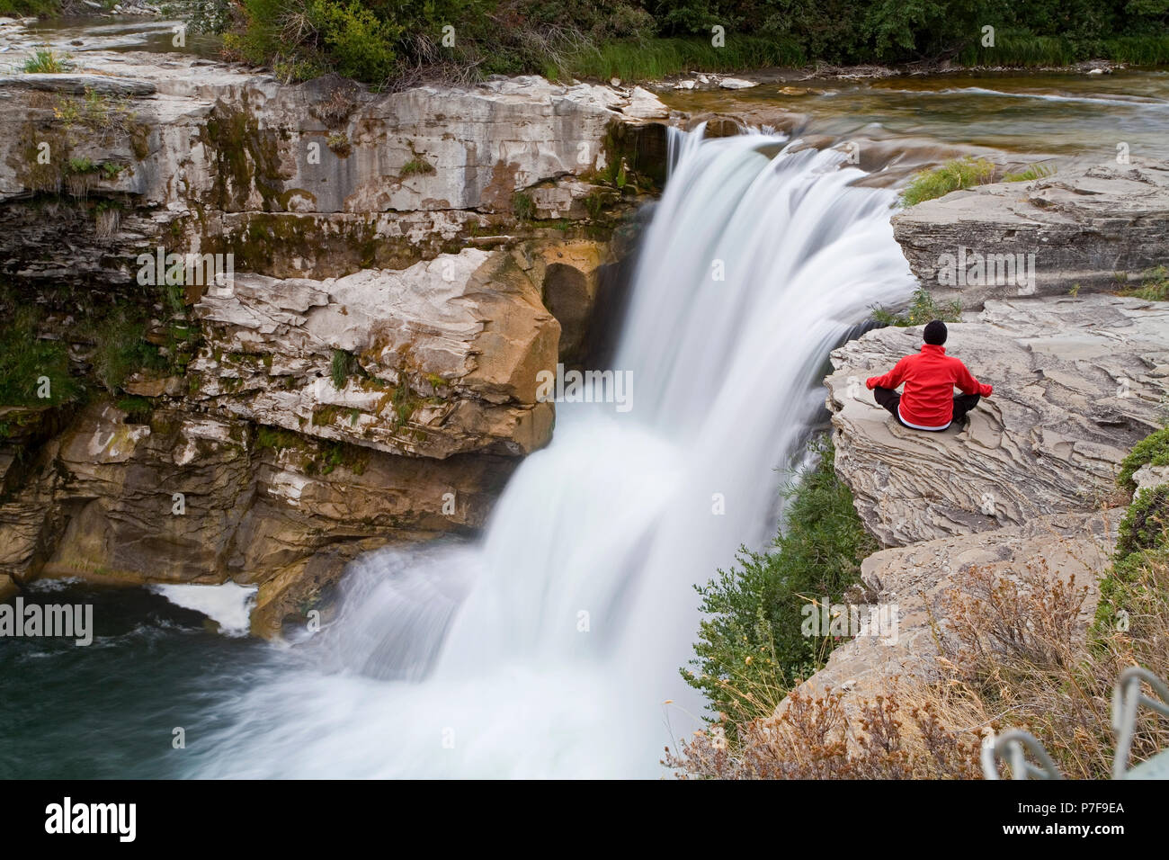 L'âge moyen homme méditant à côté de cascade, chutes de Lundbreck, Alberta, Canada. Banque D'Images