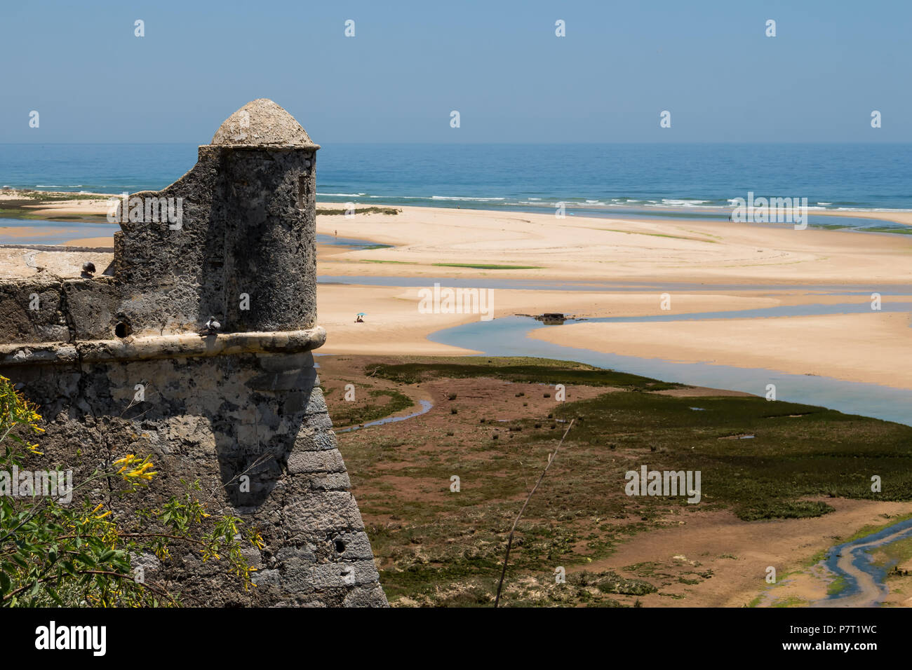 Tour de l'ancienne forteresse de pierre. Vue sur une plage de sable avec des flaques après une marée haute. Horizon de l'océan Atlantique. Ciel bleu. Cacela Velha, Banque D'Images