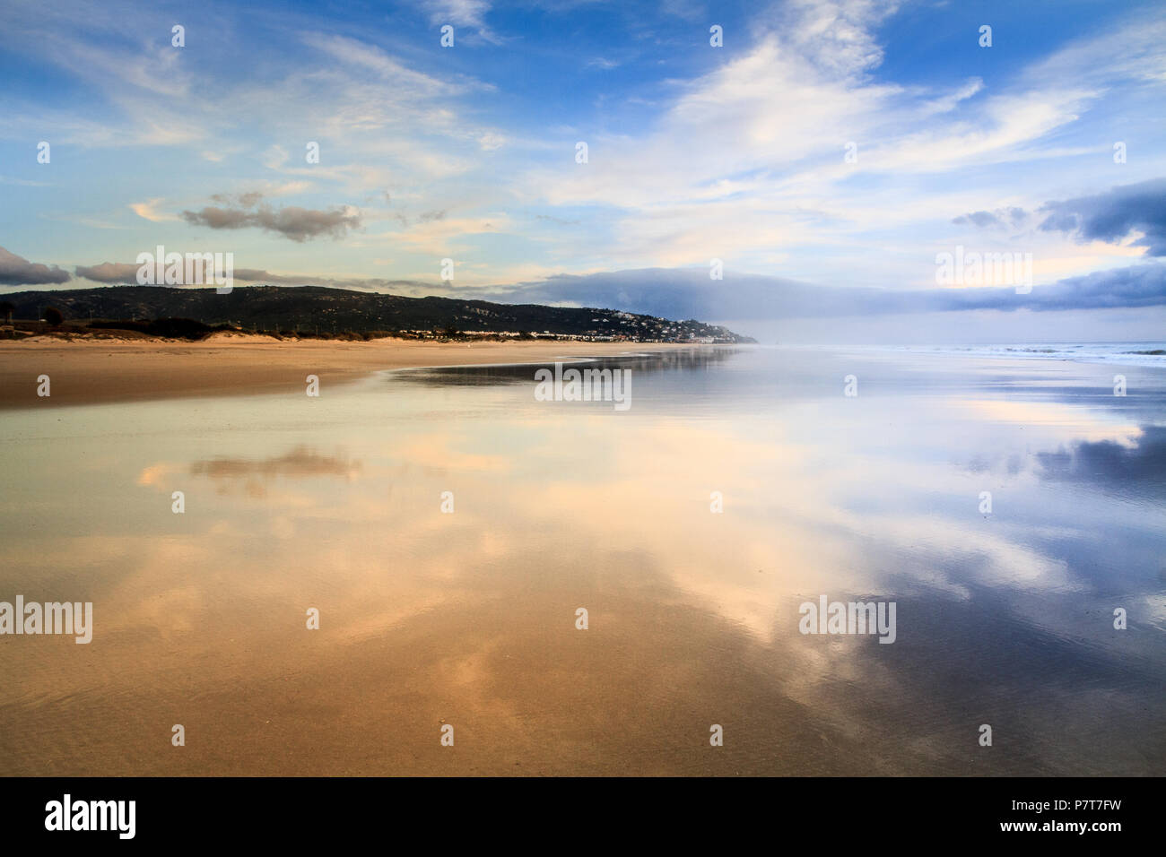 Sky reflète dans l'eau de la plage de sable humide, l'eau de mer de l'océan, plage de sable de Tarifa, Andalousie, Espagne Banque D'Images