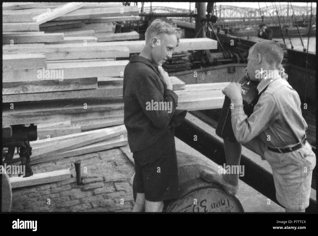 La Lettonie, Riga : Zwei Menschen vor einem Jungen, Stapel Holz. Mai 1937 74 CH-NB - Lettonie, Riga- Menschen - Annemarie Schwarzenbach - SLA-Schwarzenbach-A-5-17-095 Banque D'Images