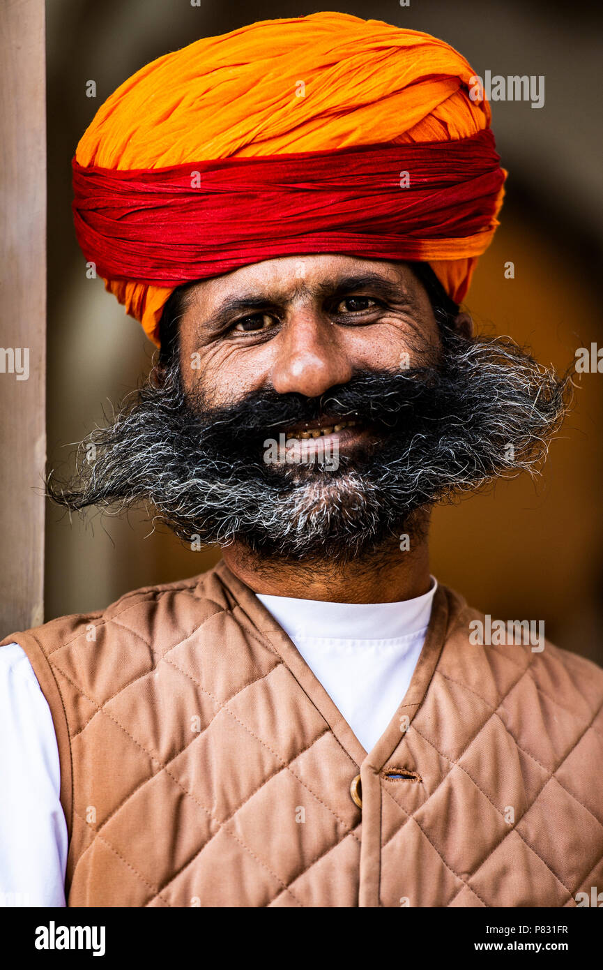 Jaipur - Rajasthan - Inde - 12 décembre 2017. Portrait of a smiling man rajasthani avec moustache, barbe et un turban traditionnel rouge et orange. J Banque D'Images