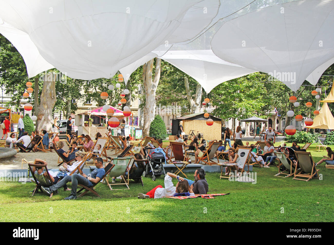 ZAGREB, CROATIE - Juillet 7th, 2018:ouverture du Festival dans le parc Zrinjevac Ville quand de nombreuses personnes avec des livres de lecture et des boissons en Zrinjevac Banque D'Images