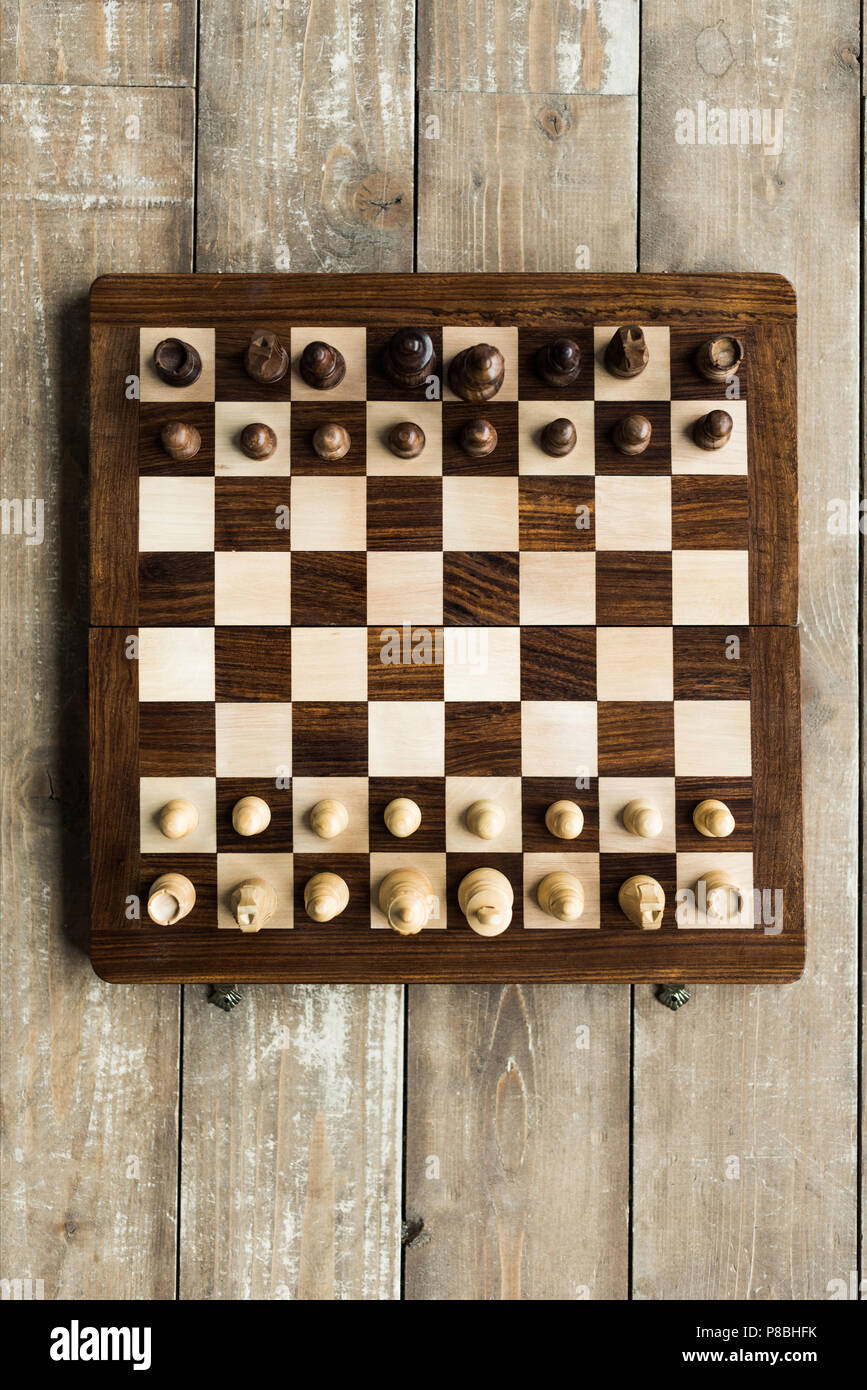 Vue de dessus de l'échiquier avec les pièces des échecs pour nouveau jeu sur la surface en bois Banque D'Images