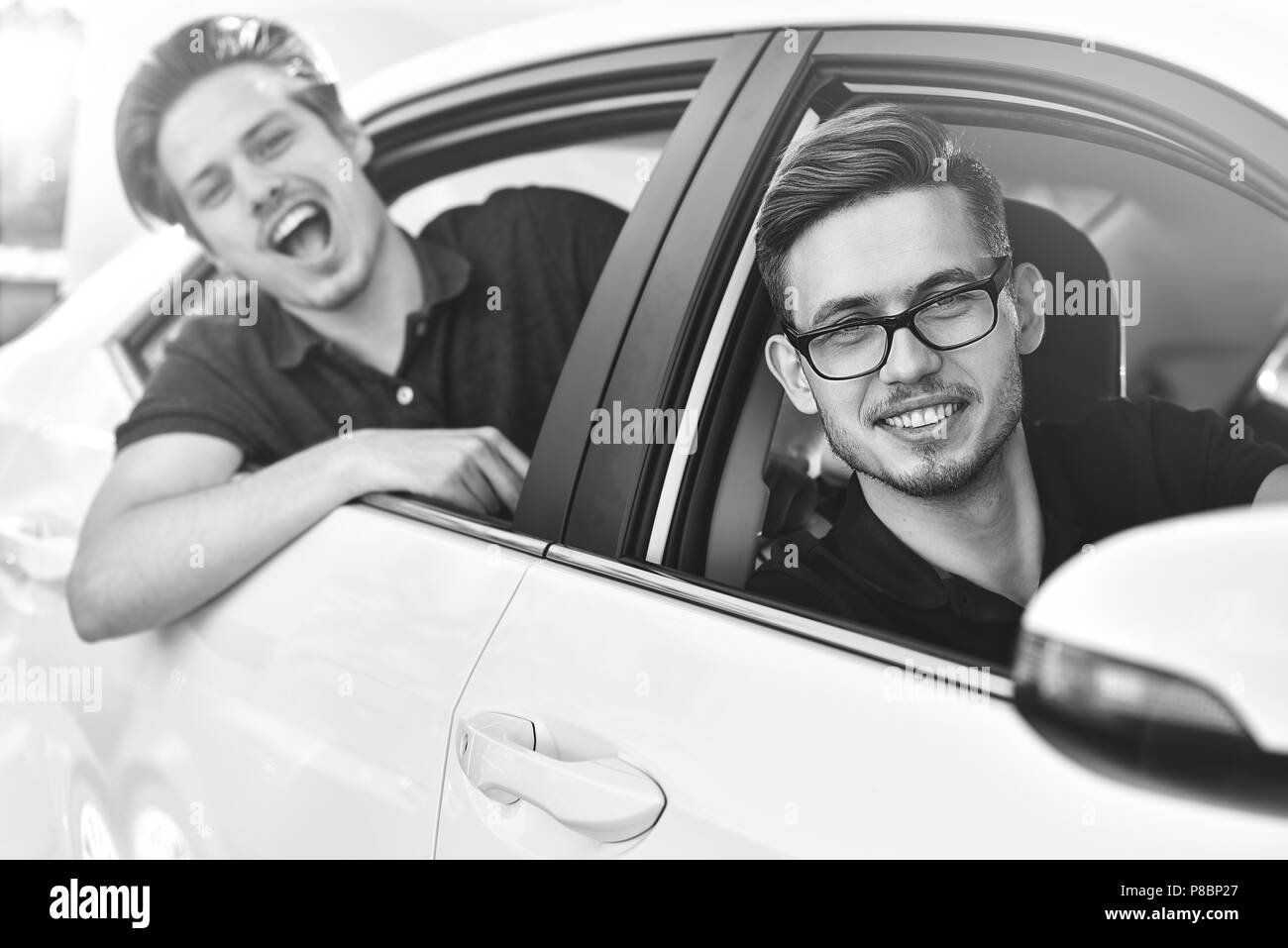 Heureux homme assis sur une voiture Banque d'images noir et blanc - Alamy