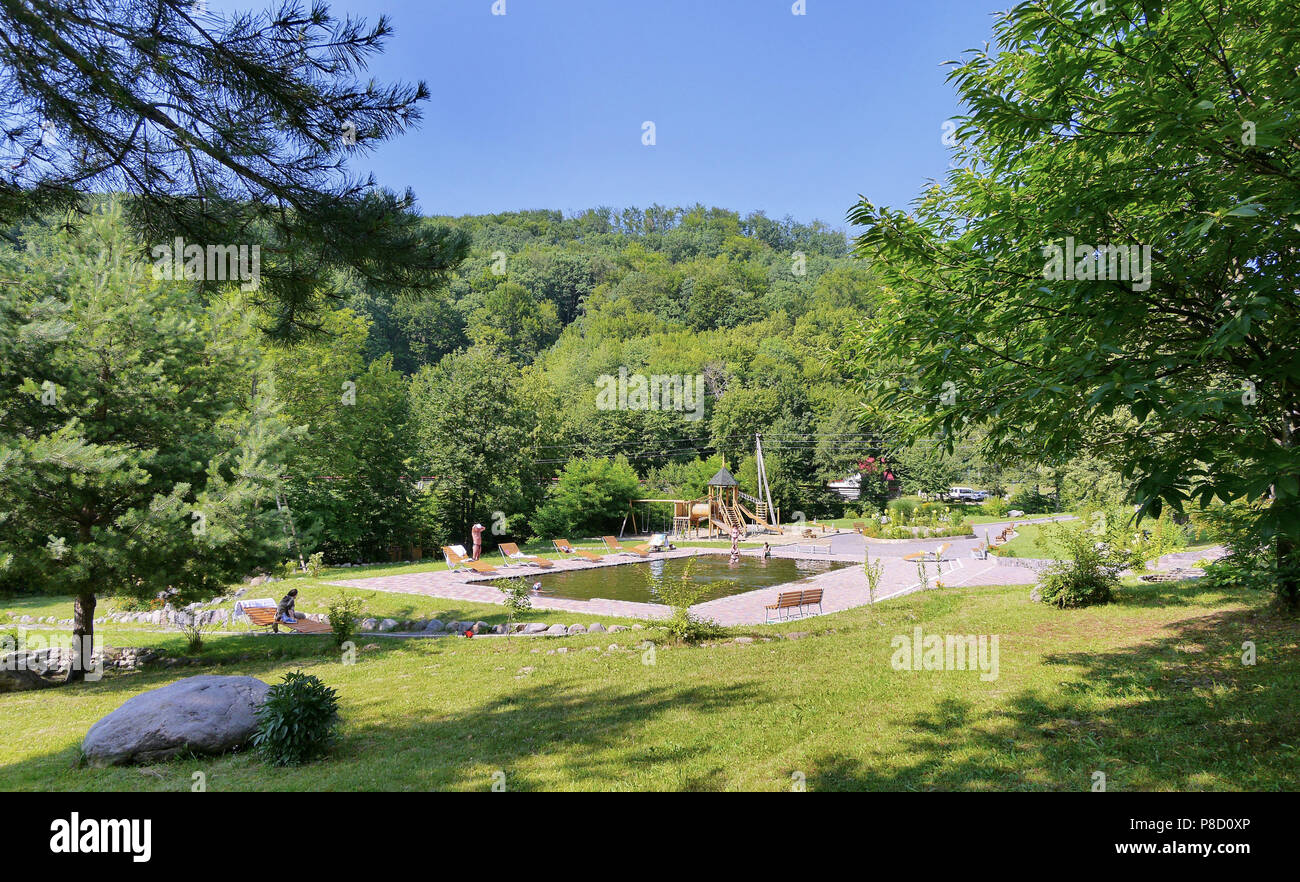 Piscine très propre avec des bancs en bois, des chaises longues et une aire de jeux dans le contexte de la zone du parc . Pour votre conception Banque D'Images Piscine très propre avec des bancs en bois, des chaises longues et une aire de jeux dans le contexte de la zone du parc . Pour votre conception Banque D'Images