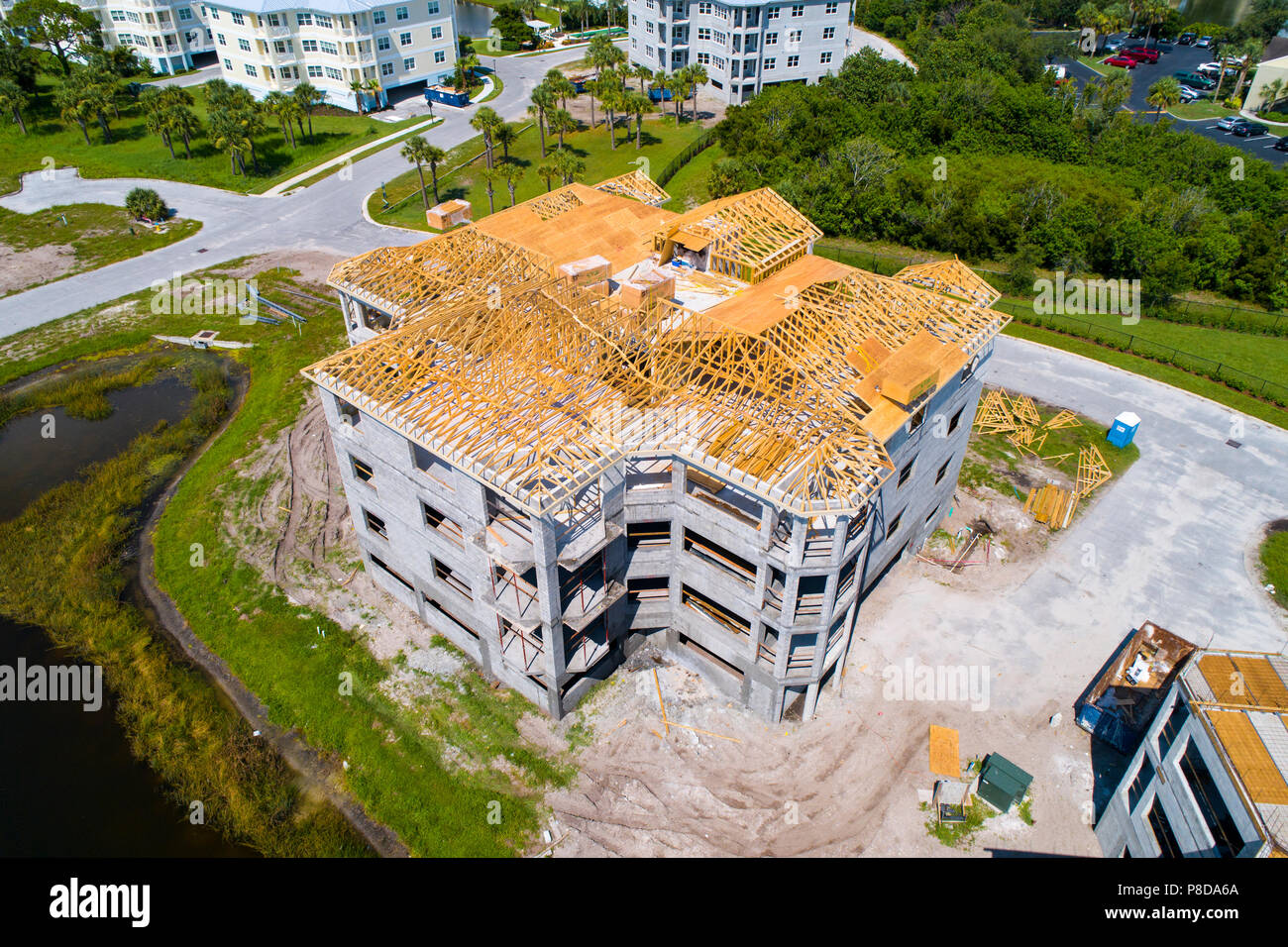 Vue aérienne de la construction de nouvelles habitations en copropriété avec ossature en bois au sommet d'un bloc de ciment de 9 unités d'accueil individuel Banque D'Images