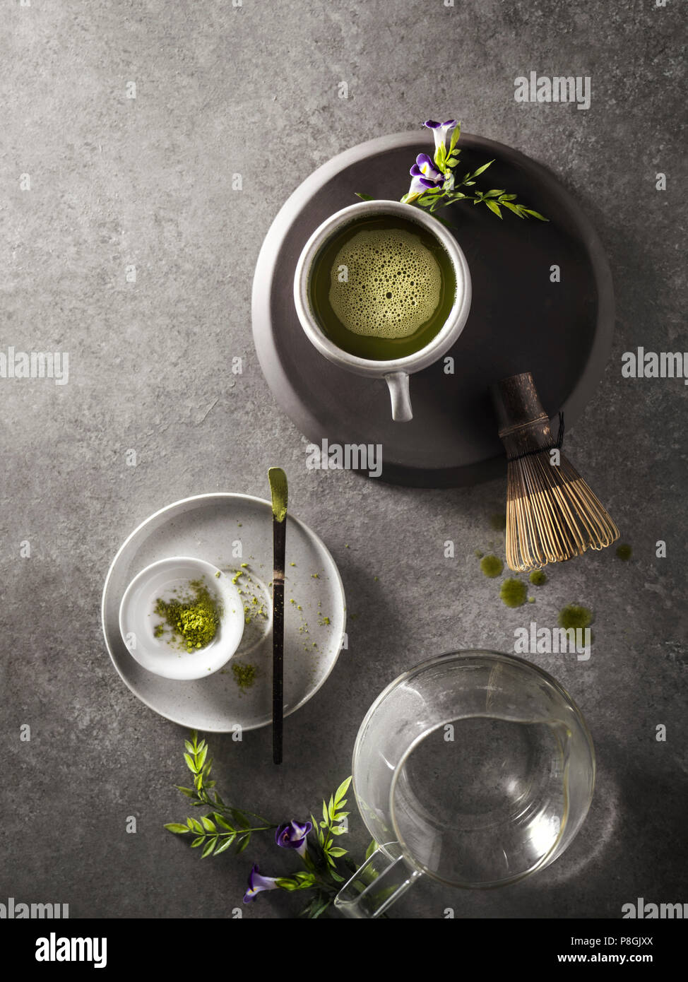 Une bonne tasse de thé vert matcha qui vient d'être préparé avec un fouet en bois et verre à l'arrière-plan. Banque D'Images