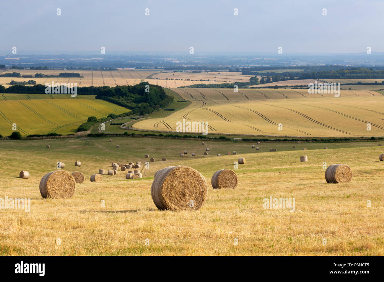 Balles de foin rondes et une vue sur les terres agricoles de l'Oxfordshire au-dessus de la ville de Wantage vu du sentier de Ridgeway, Oxfordshire, Angleterre, Royaume-Uni Banque D'Images