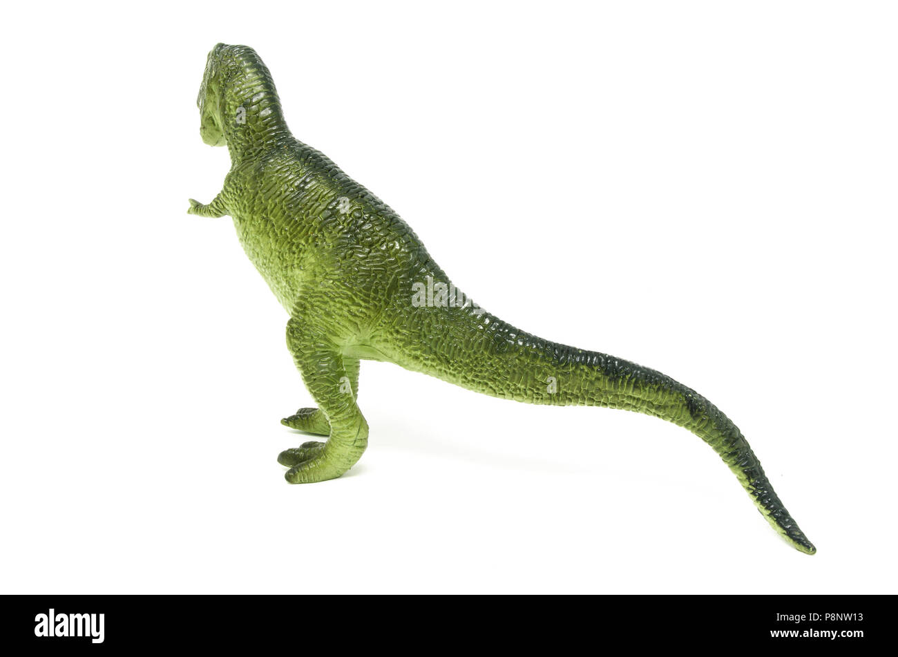 Retour de vert en plastique jouet dinosaure Tyrannosaurus rex, isolé sur un fond blanc. Banque D'Images