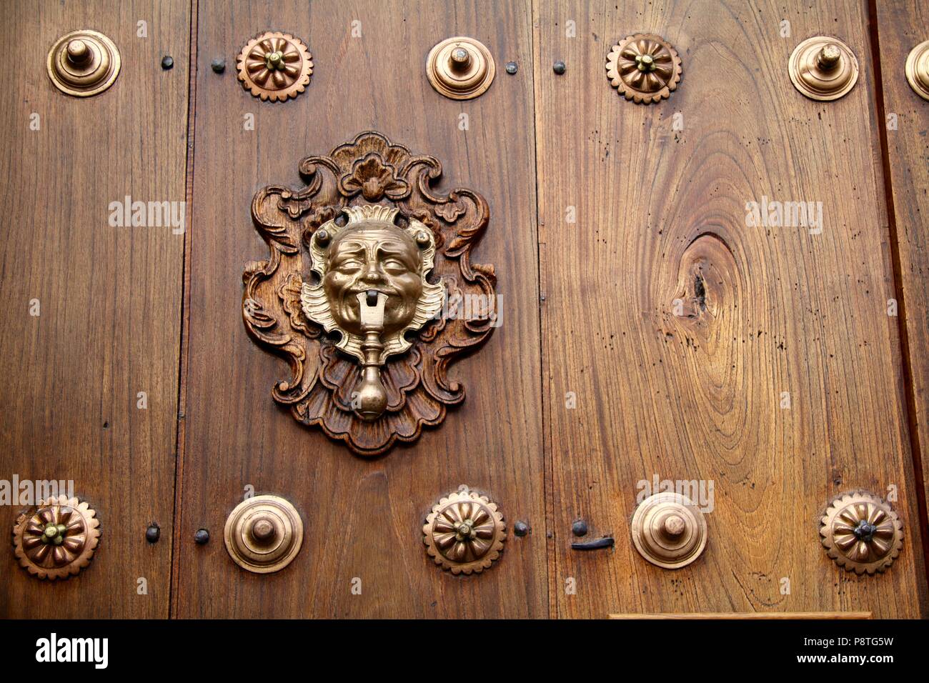 Porte en bois cloutée poli fraîchement avec heurtoir or Banque D'Images