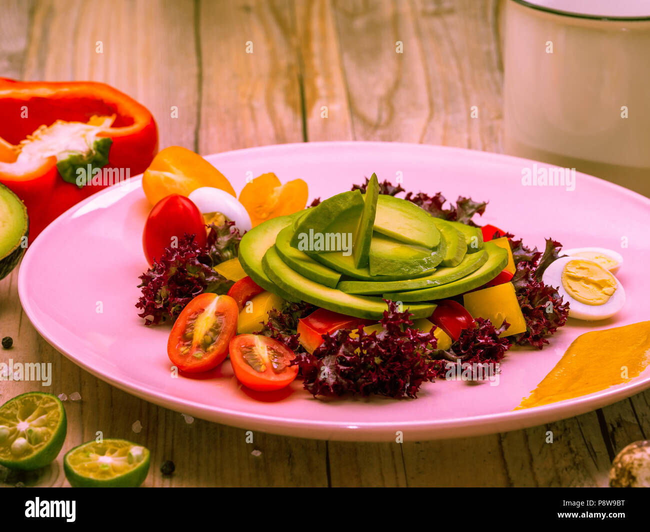Salade d'alimentation avec des tomates cerises, des oeufs de cailles, jaune et le poivron rouge et la laitue. L'avocat est source de nutrition, de vitamines. Studio shot. Banque D'Images