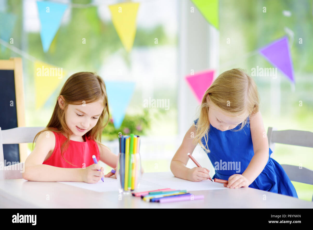 Deux sœurs mignon petit dessin avec des crayons de couleur dans une