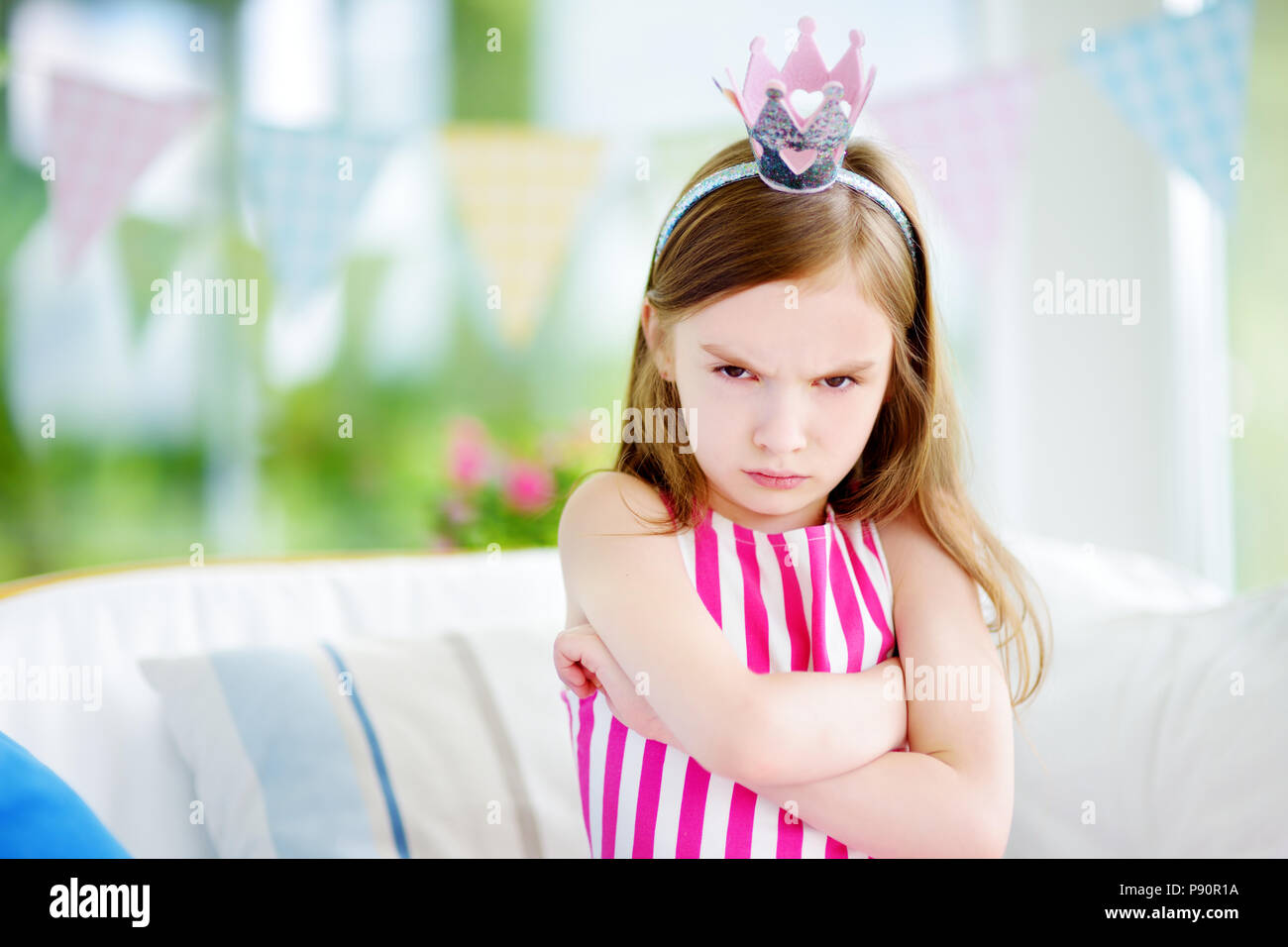 Moody little girl wearing princess tiara se sentir en colère et mécontent. Les enfants de colère concept. Banque D'Images