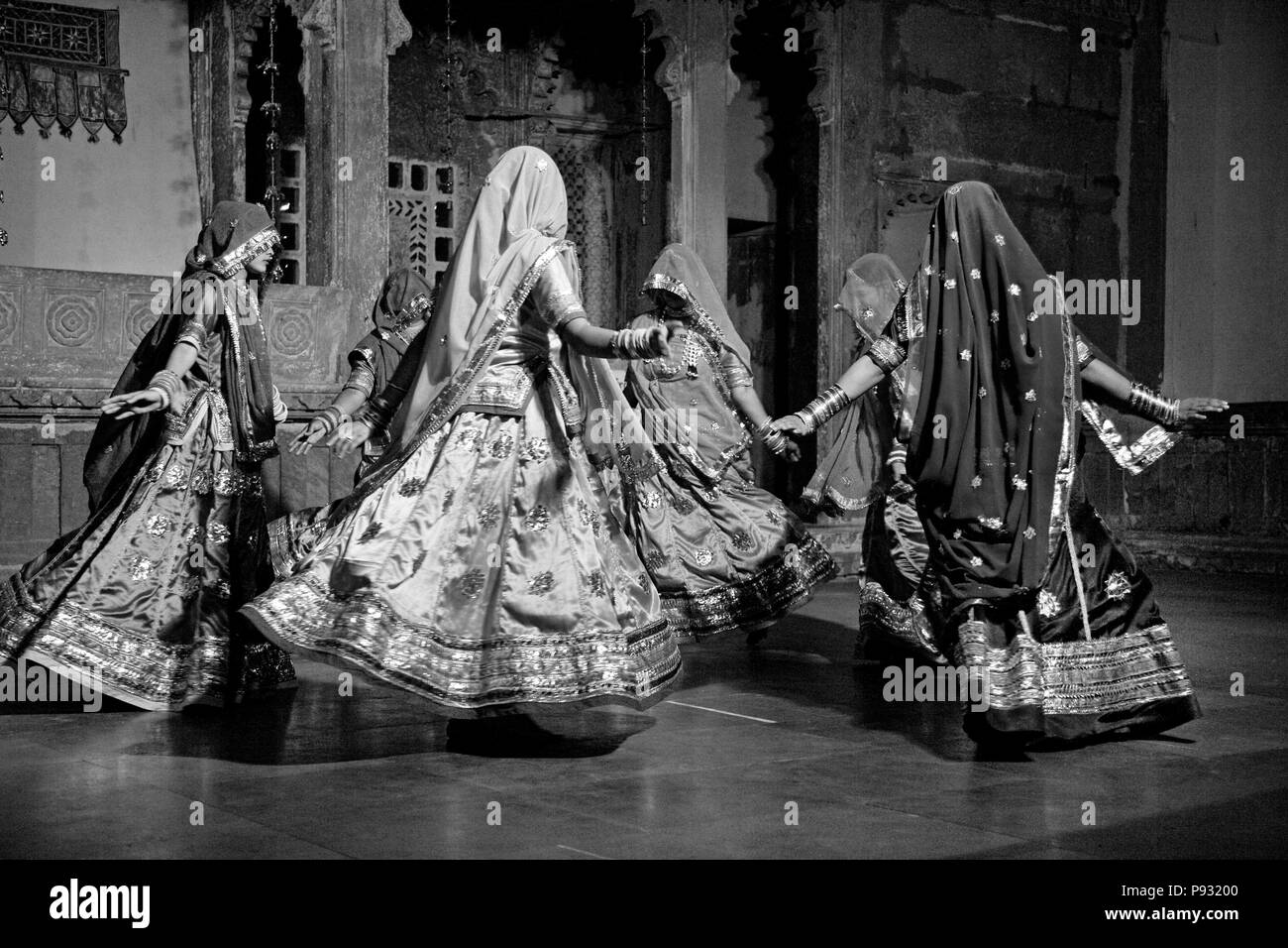 Les femmes du Rajasthan effectuer une danse traditionnelle dans leurs robes de soie colorés au MUSÉE BAGORE KI HAVELI Udaipur - Rajasthan, INDE Banque D'Images