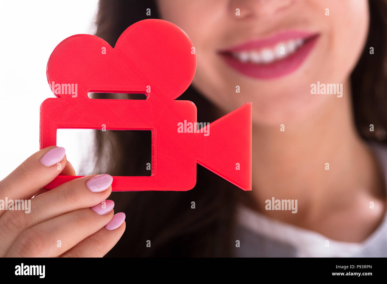 Photo de Woman's Hand Holding Red Movie Camera Banque D'Images