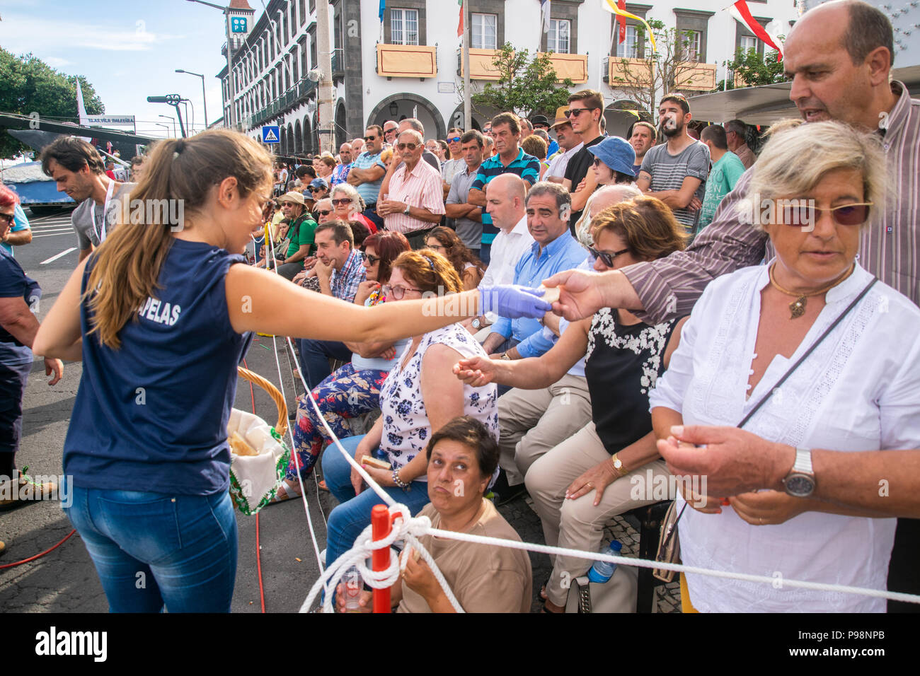 Ponta Delgada, Açores, Portugal - 07/07/2018 - Jeune fille de Vila das Capelas en donnant de la nourriture à la population sur le divin Esprit Saint célébration Banque D'Images