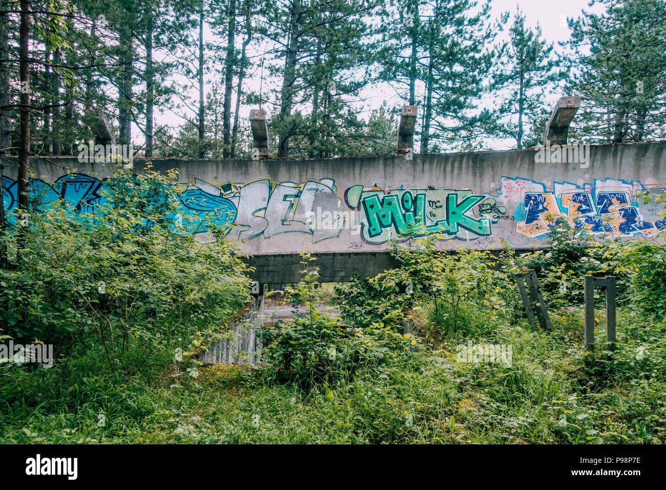 Le désormais ancien béton des Jeux Olympiques de Sarajevo 1984 piste de bobsleigh et de luge à travers la forêt des courbes, couverts de graffitis Banque D'Images