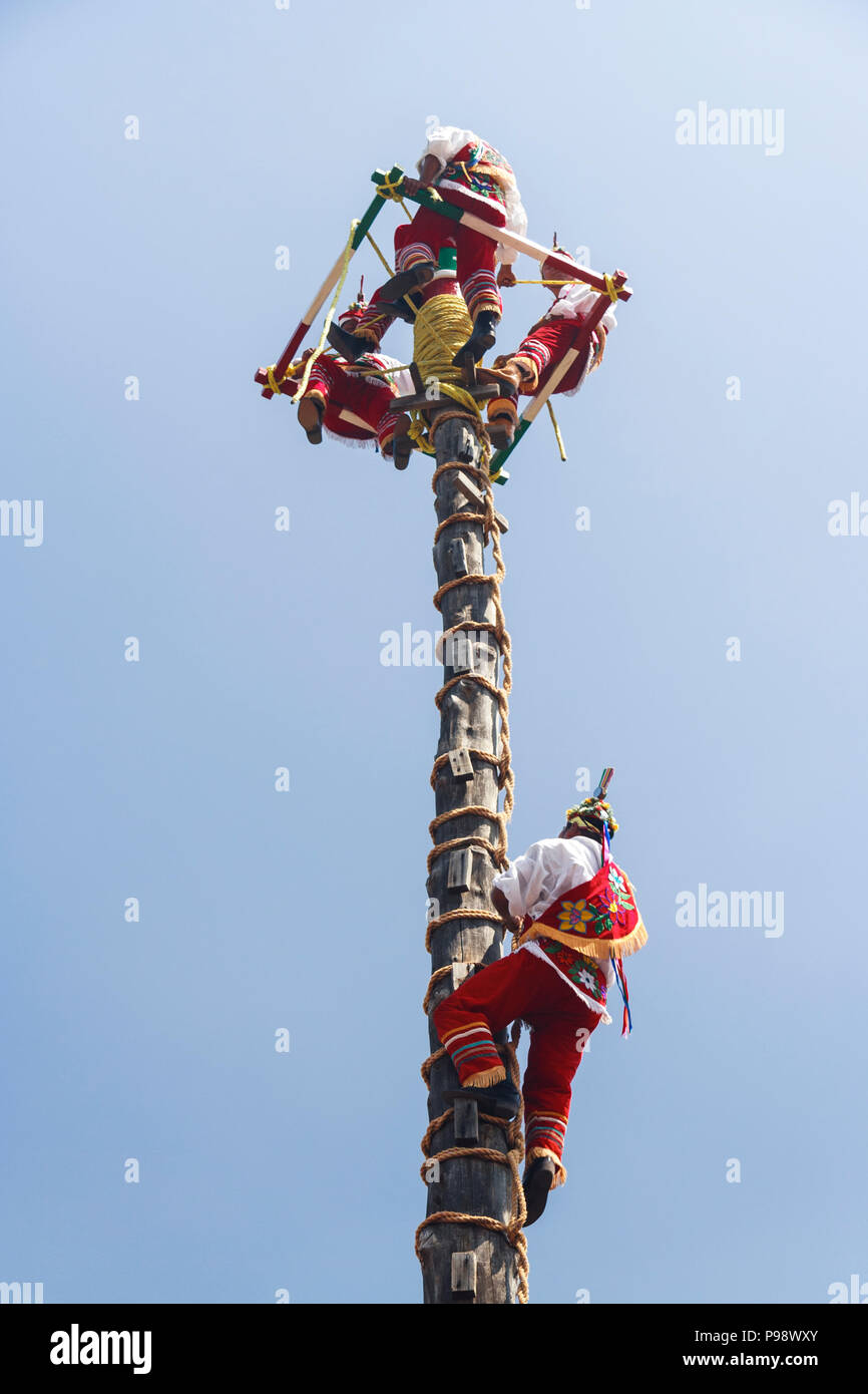 Teotihuacan, Mexique : les hommes en vêtements traditionnels Totonaques l'escalade 30 ms pole des Voladores ou hommes volants d'une cérémonie nommée patrimoine culturel Banque D'Images