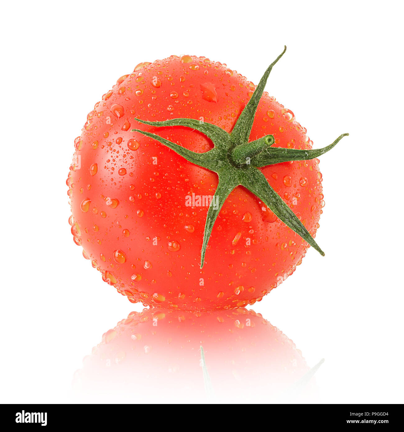 Tomate mûre avec des feuilles vertes Banque D'Images