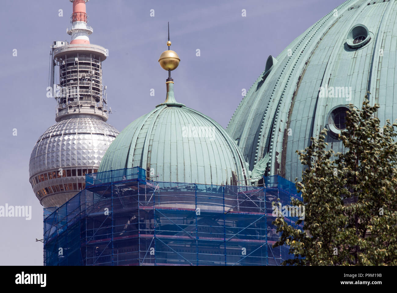 Berlin, Allemagne. 18 juillet, 2018. La tour de télévision derrière les dômes de la cathédrale de Berlin. La tour nord-ouest est en travaux extérieurs pour échafaudée. Crustification, en raison de la rouille, l'usure en caoutchouc, et la poussière, s'est formé au fil des ans. Credit : Soeren Stache/dpa-Zentralbild/ZB/dpa/Alamy Live News Banque D'Images