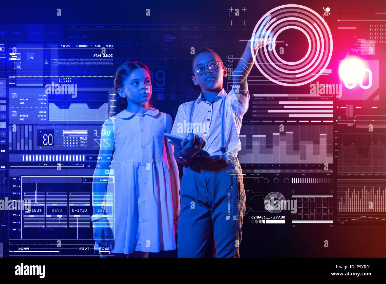 Garçon calme tenant un smartphone et pointant vers l'écran Banque D'Images