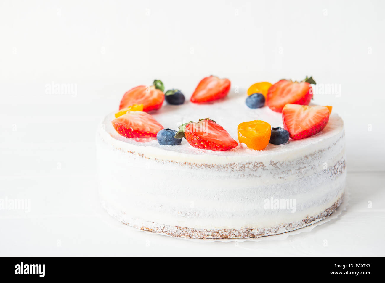 Yaourts crémeux délicieux gâteau sain avec des fraises, bleuets sur le fond blanc. Photo d'un menu ou d'une confiserie catalogue. Sel Banque D'Images