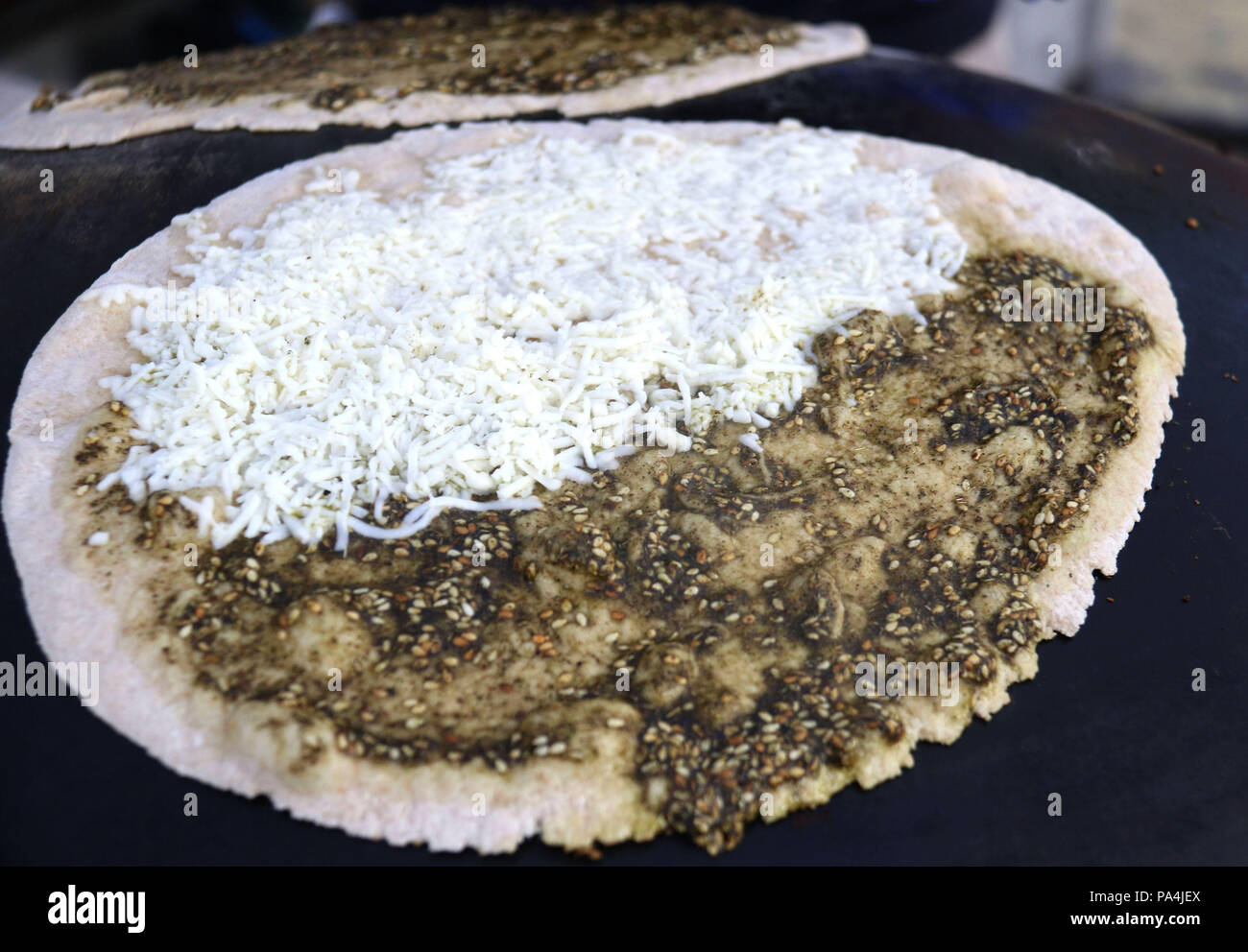 Mankousheh, un pain plat libanais à base de thym, l'huile, les épices et le fromage sur un saj four Banque D'Images