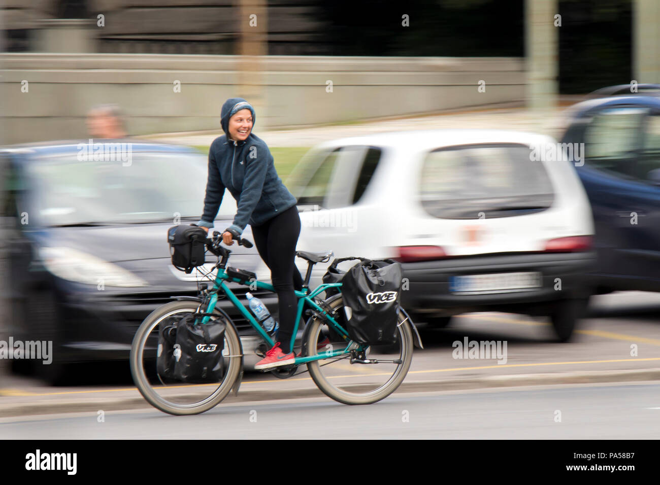 Belgrade, Serbie - le 24 juin 2018 : Jeune femme , Vice-reporter, d'une bicyclette en position debout et à sourire de nouveau à quelqu'un, on city street Banque D'Images