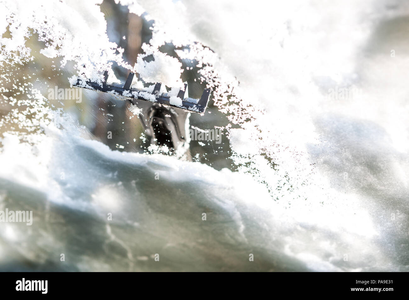 Nettoyage de fenêtre de voiture de la neige et de la glace. Le grattage de la glace sur un pare-brise a été prise par l'intérieur de la voiture. Hiver Transport Banque D'Images