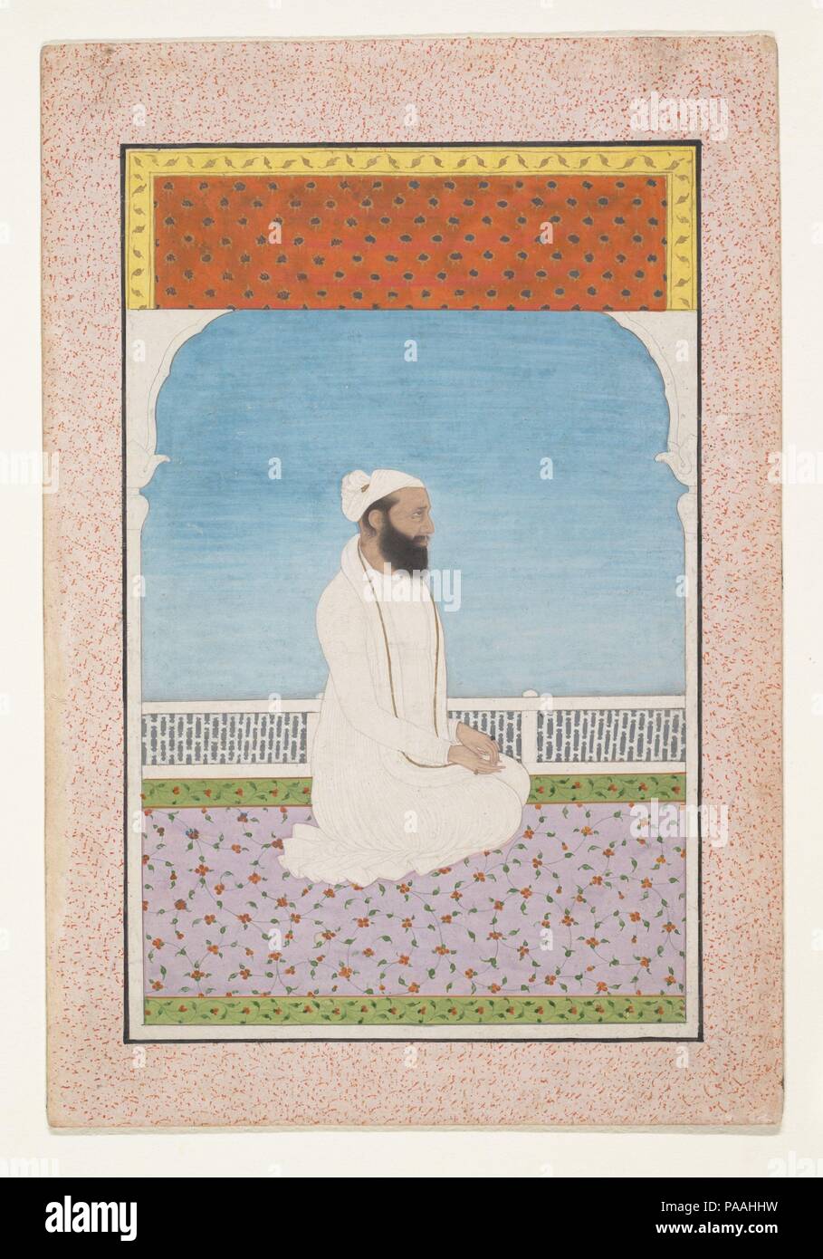 Un saint homme assis sur une terrasse. Culture : l'Inde (Pendjab, collines) de Kangra. Dimensions : 6 1/2 x 4 1/4 in. (16,5 x 10,8 cm). Date : ca. 1850. L'artiste a utilisé le paramètre magistralement clairsemée pour souligner son sujet. La figure est placée contre un ciel pâle est diplômé de blues, encadrée sur les côtés par une arche de marbre et au-dessus par un tissu d'aveugles, l'orange et de jaune chaud qui contraste avec le tapis rose avec une bordure verte plus doux dans la partie inférieure de la page. Le blanc de la robe de saint homme aveugle semble dans sa blancheur Stark. Ces traités habilement effets coloristic a préparé le terrain pour le s Banque D'Images