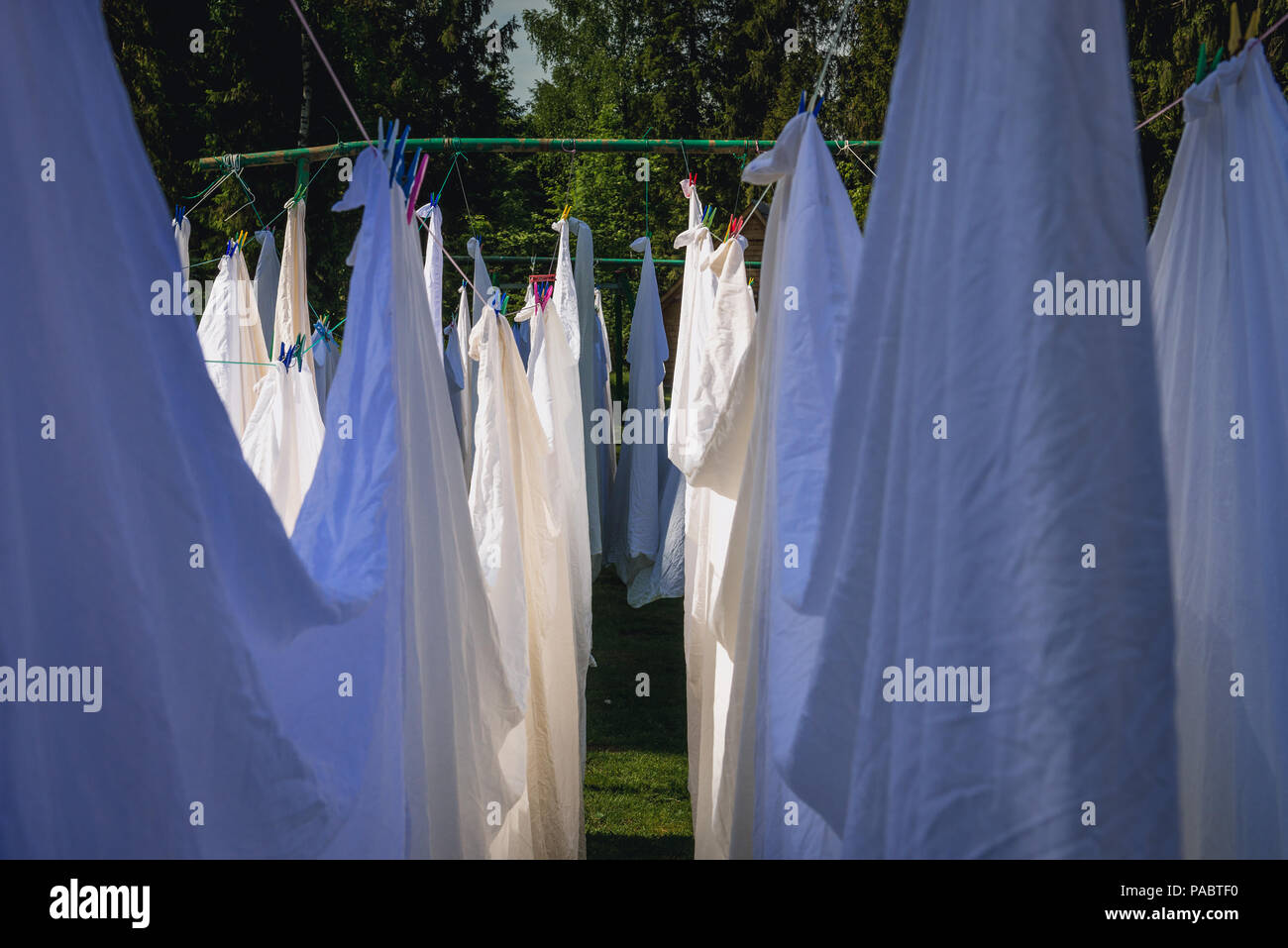 Le linge de lit blanc à gauche pour le séchage dans jardin Banque D'Images