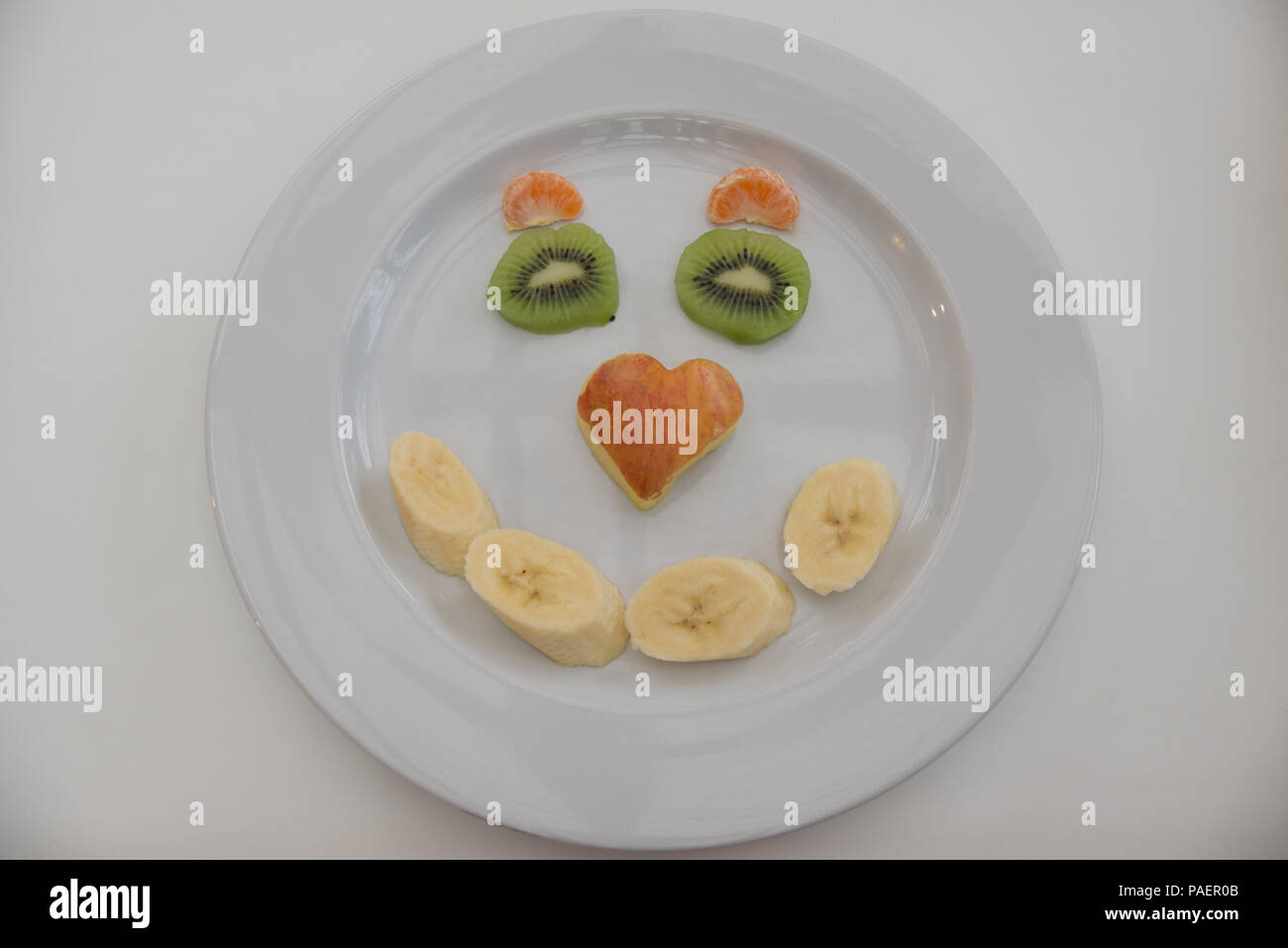 Visages de fruits pour les difficiles, aider vos enfants à bien manger en s'amusant Banque D'Images