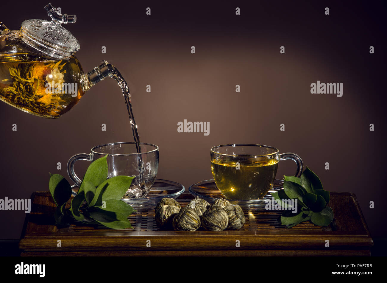 Théière en verre tasse thé vert en débit sur fond brun, cérémonie du thé Banque D'Images