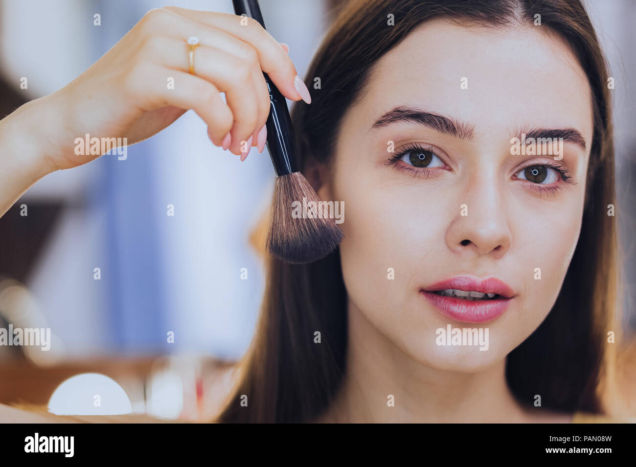 Dark-haired woman holding ring nice brosse visage Banque D'Images