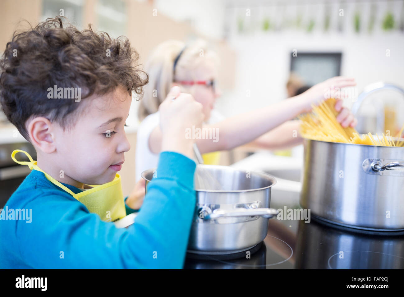 Les élèves de préparer les pâtes en cours de cuisine Banque D'Images