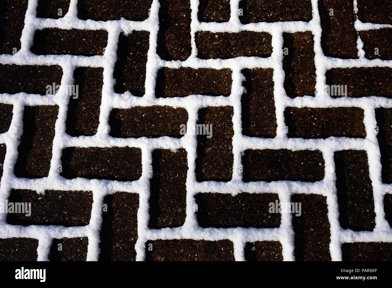 Pavage de bloc de neige entre les briques, Angleterre, Royaume-Uni, Europe de l'Ouest. Banque D'Images