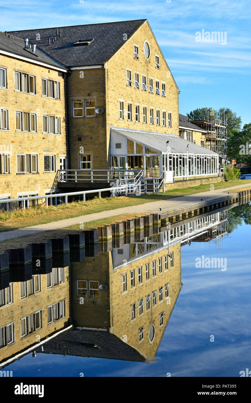 Rendezvous Hotel & restaurant Conservatory reflète dans l'eau encore de Leeds Liverpool Skipton Canal Passerelle vers le nord du Yorkshire Dales England UK Banque D'Images